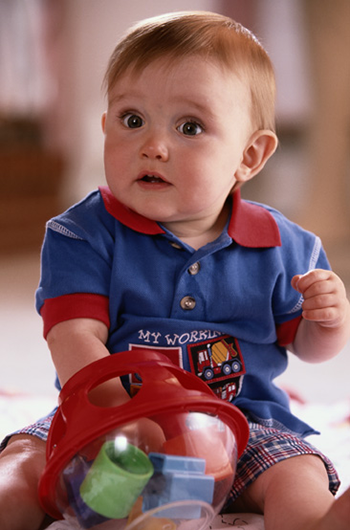 a toddler is playing with colored blocks. This is a decorative image.